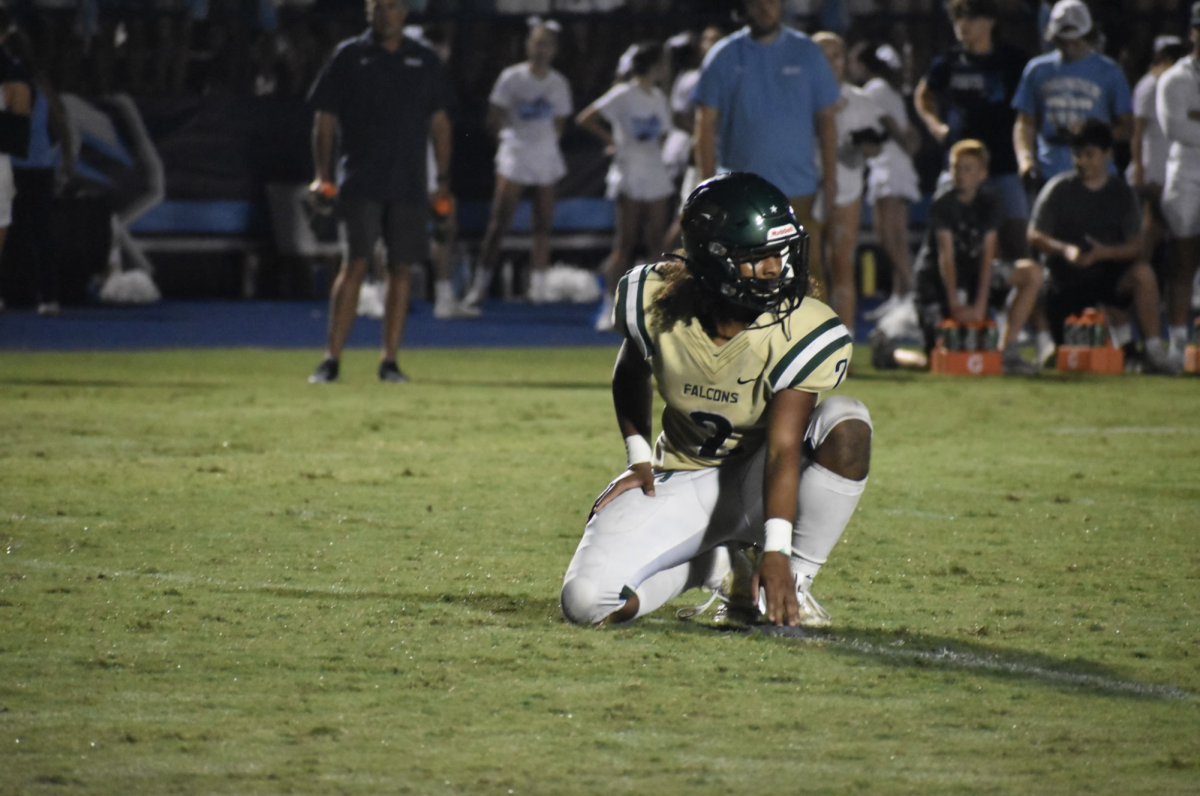 Senior captain Evan Brown prepares for junior Gavin Winterhalter to kick a field goal.