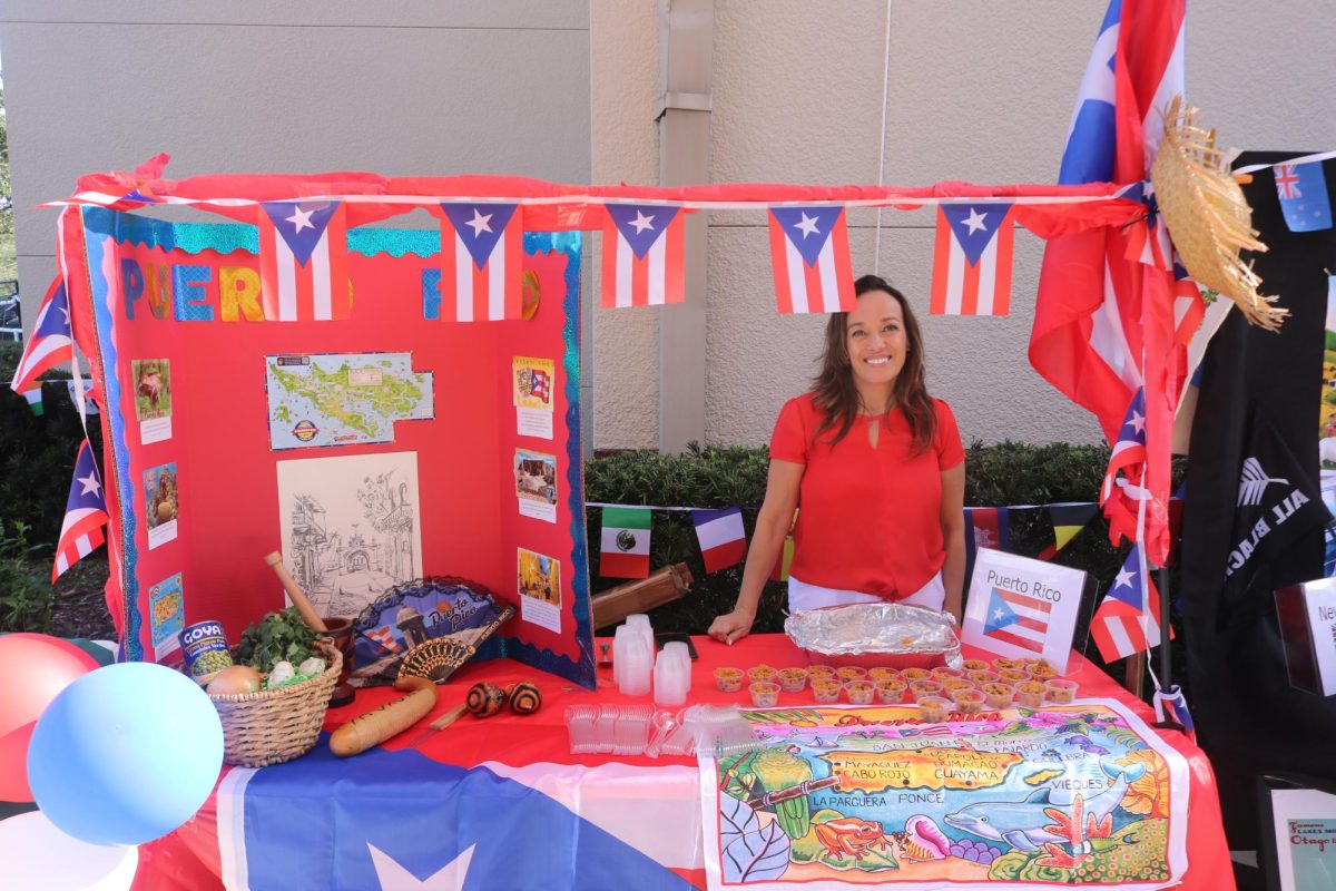 Michele Lamourt, mother of sophomore James Haley, running the stand dedicated to Puerto Rico.  Lamourt shared a delicious mix of rice and peas