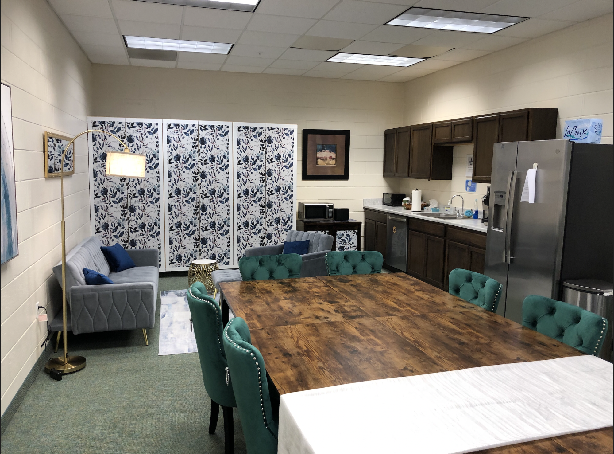 The updated Faculty Lounge features a long, communal table, updated chairs and couches, and some sleek designs on the cabinets.