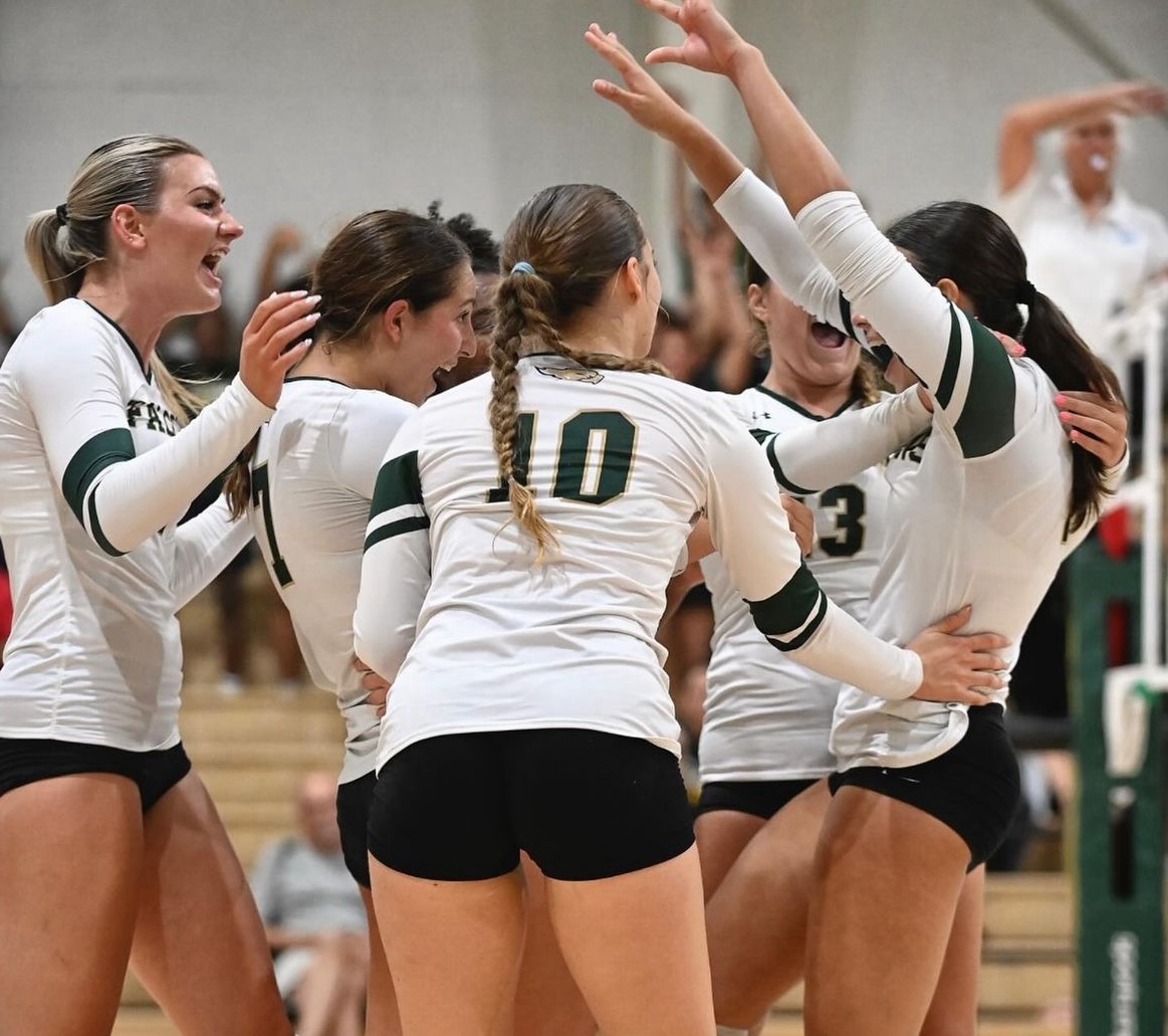 Members of the girls volleyball team celebrate a point.  The girls are 3-0 this season.