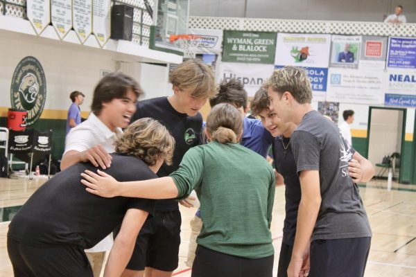  A shot of the junior boy's volleyball team playing in a match at lunch. 