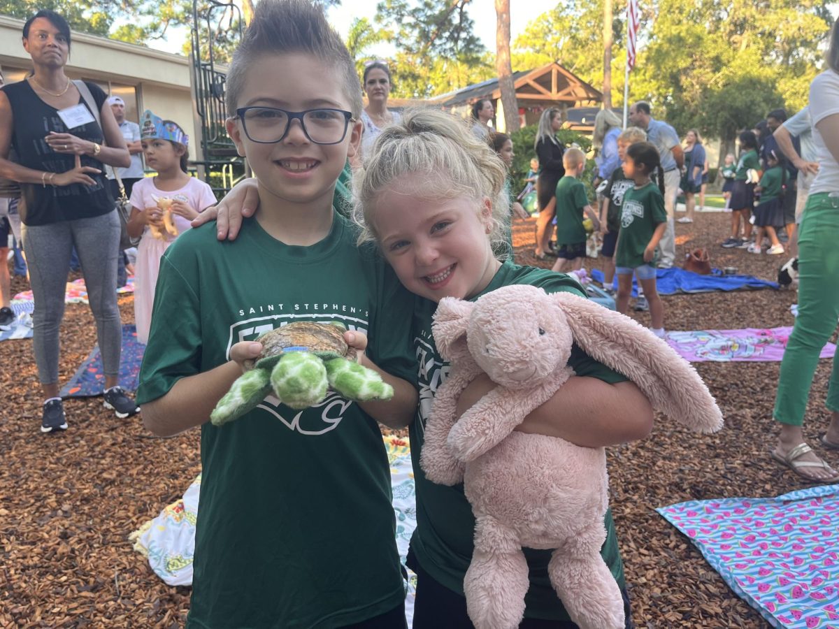 Two friends excitedly pose with their stuffed animals.