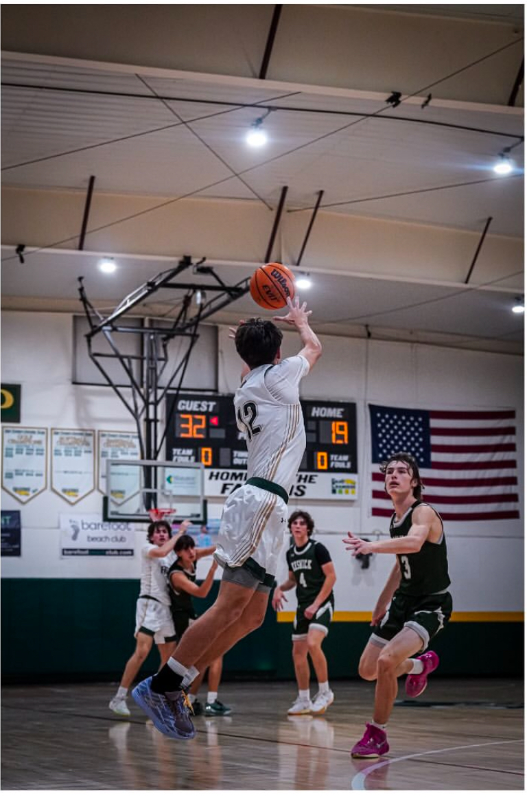 Aymon Colton mid three guarded by opposing player. 