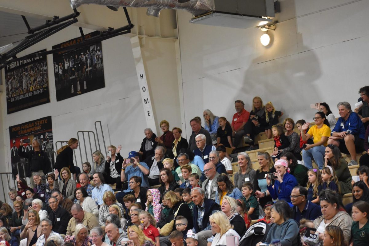 Students and their grandparents flood the gymnasium stands to watch a special show.