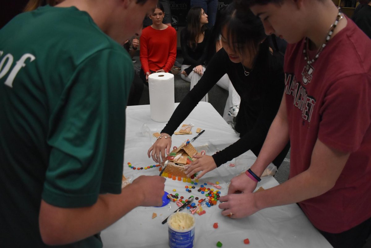 The freshmen work together to build their first gingerbread house, an annual tradition in the US. 