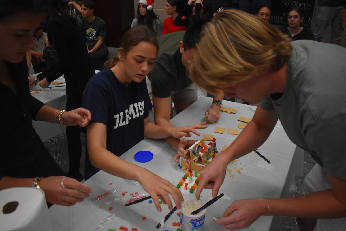 The class of 2025 pushes through to debut their last gingerbread house as Saint Stephen's students.